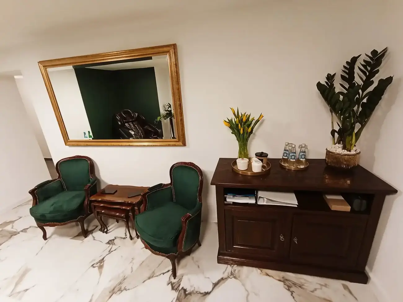 Relaxation area next to the hyperbaric chamber — massage chair and armchairs